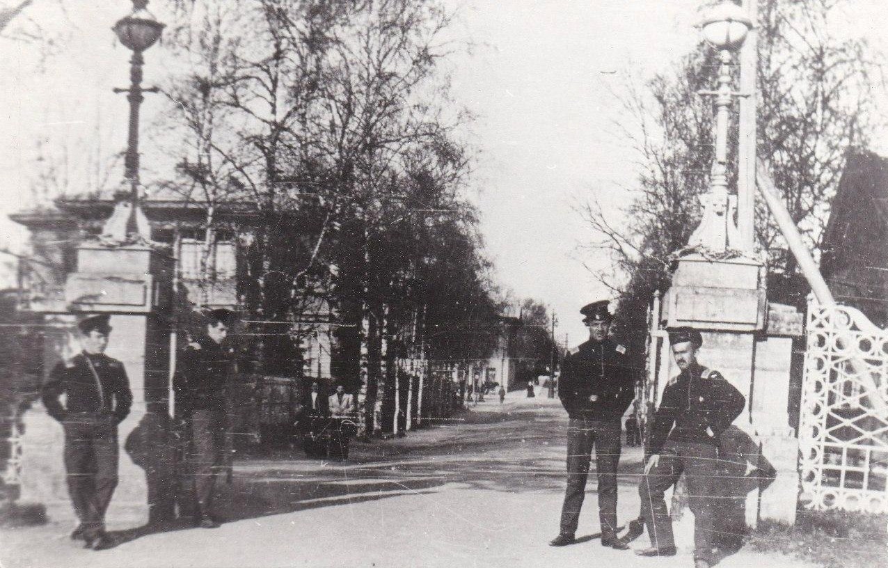 Угол Люцевской и Ксениинской (Леонова) улиц. Ворота в Приоратский парк. 
Слева: дом № 26/2 по Люцевской. На заднем плане: дом № 41 по Люцевской